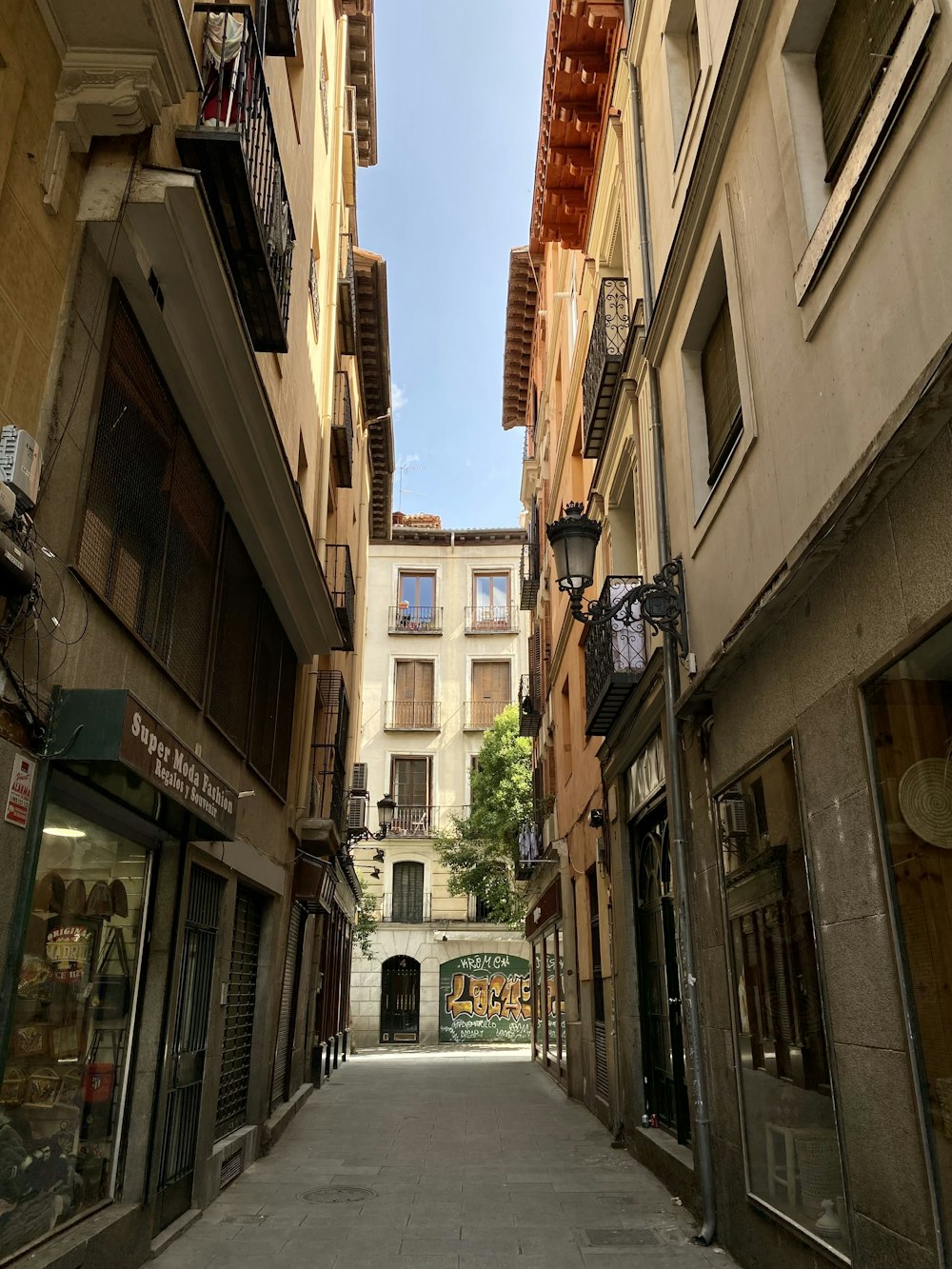 Una estrecha calle de la ciudad bordeada de edificios altos