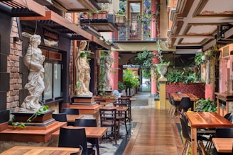 a restaurant with tables and chairs and a statue