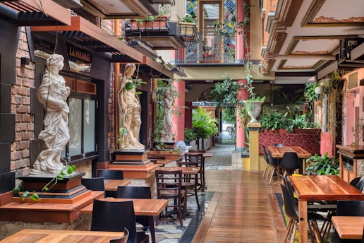 a restaurant with tables and chairs and a statue