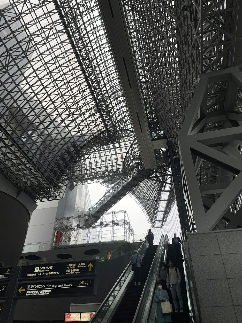 an escalator in a train station with people on the escalator