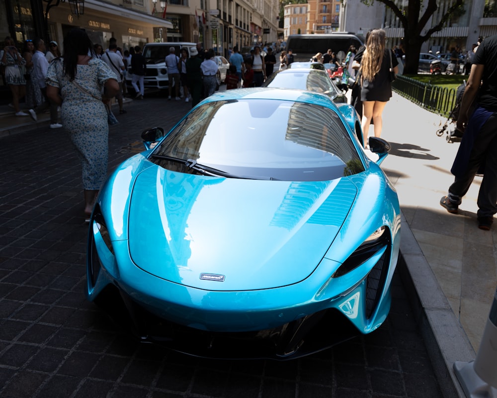 a blue sports car parked on the side of the road