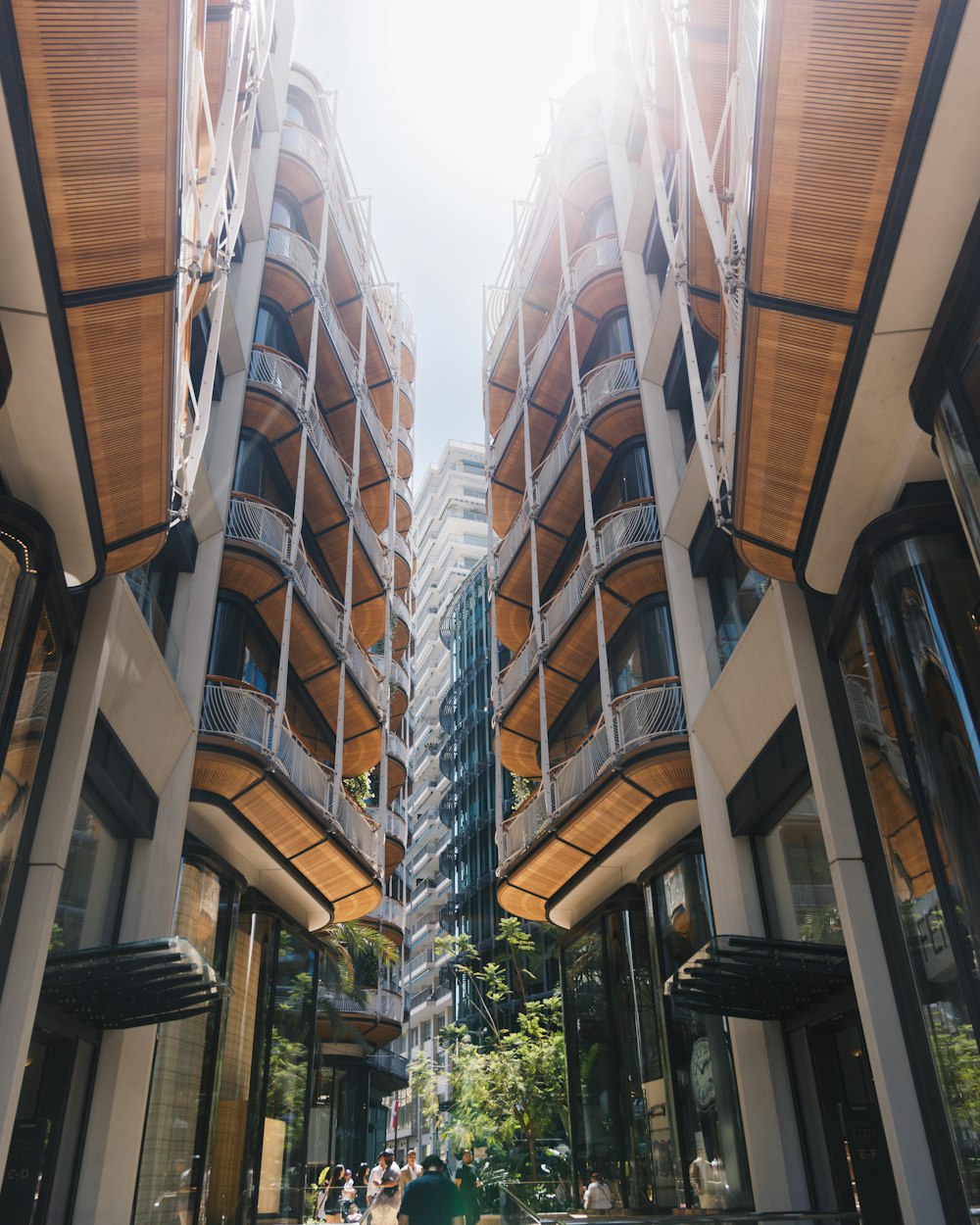 a group of people walking down a street next to tall buildings