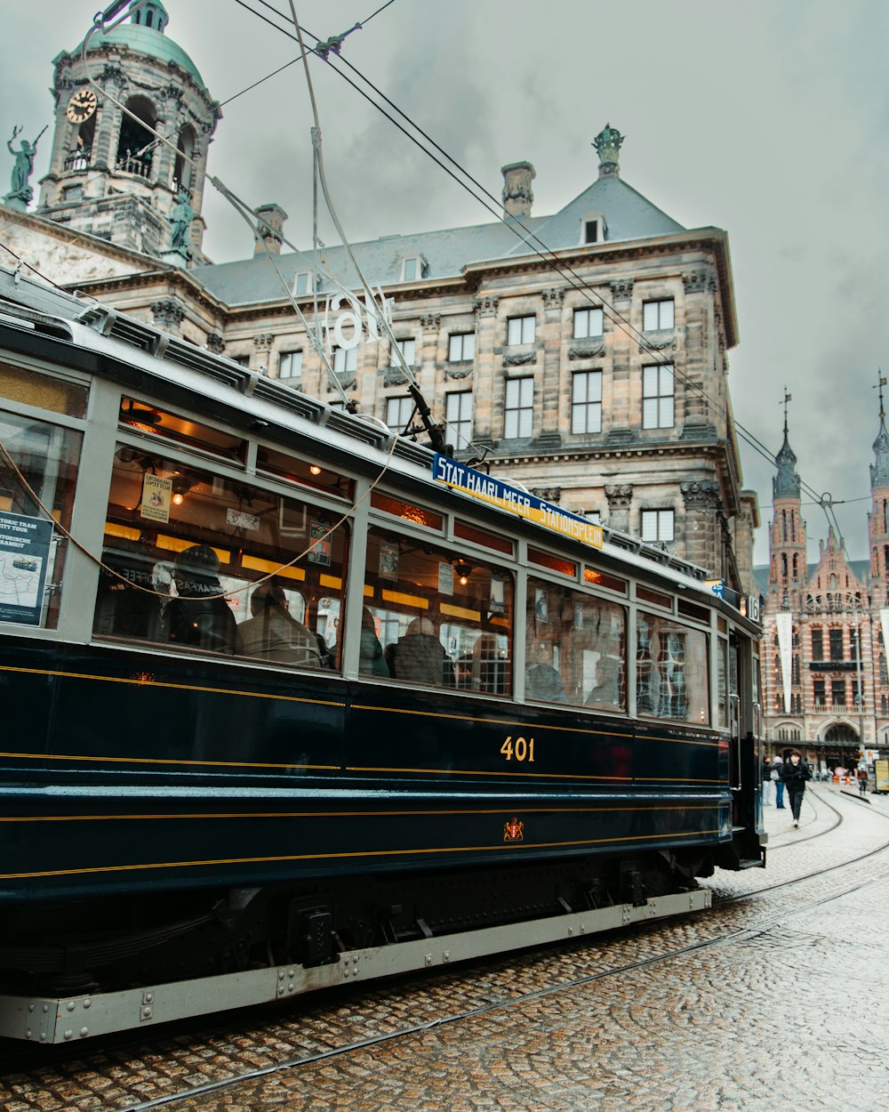 a trolley car on a cobblestone street in a european city