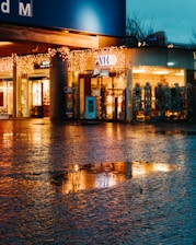 A cozy London street with boutique shop windows glowing warmly at dusk.