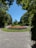 A well-maintained green lawn with vibrant flower beds under a clear blue sky.