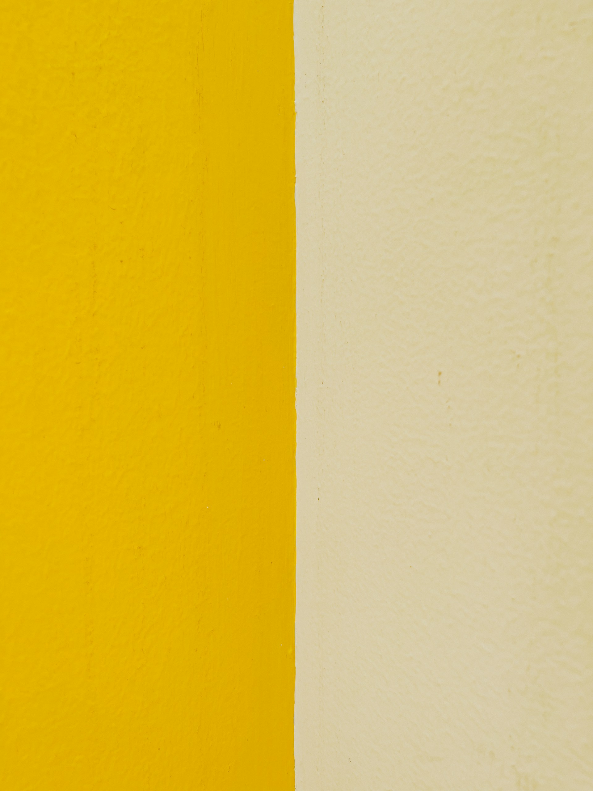 a yellow and white wall with a clock on it