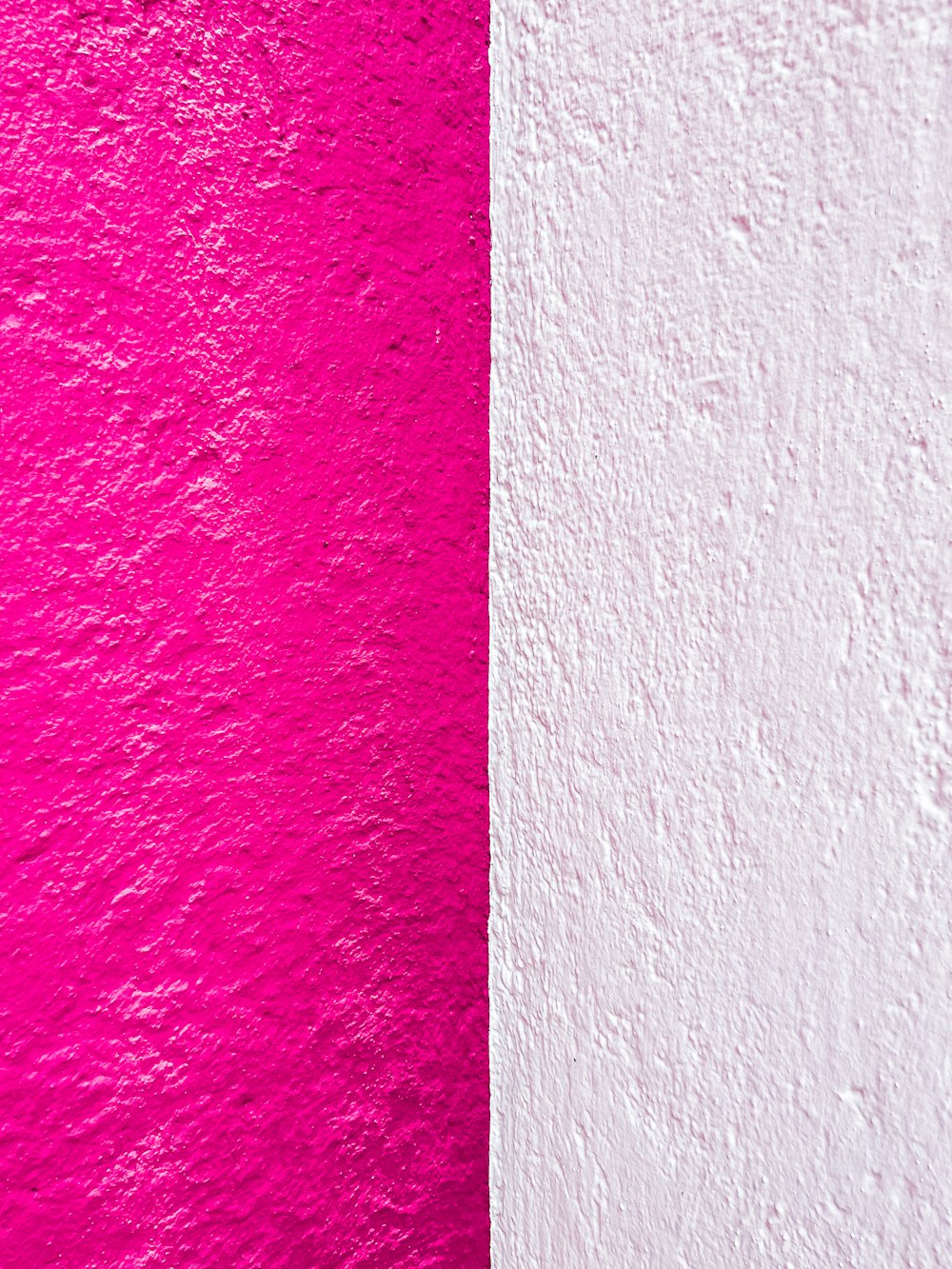 a white and pink wall next to each other