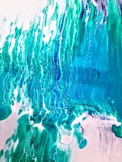 A vibrant abstract painting bursting with swirling blues and greens, evoking the depths of the ocean.