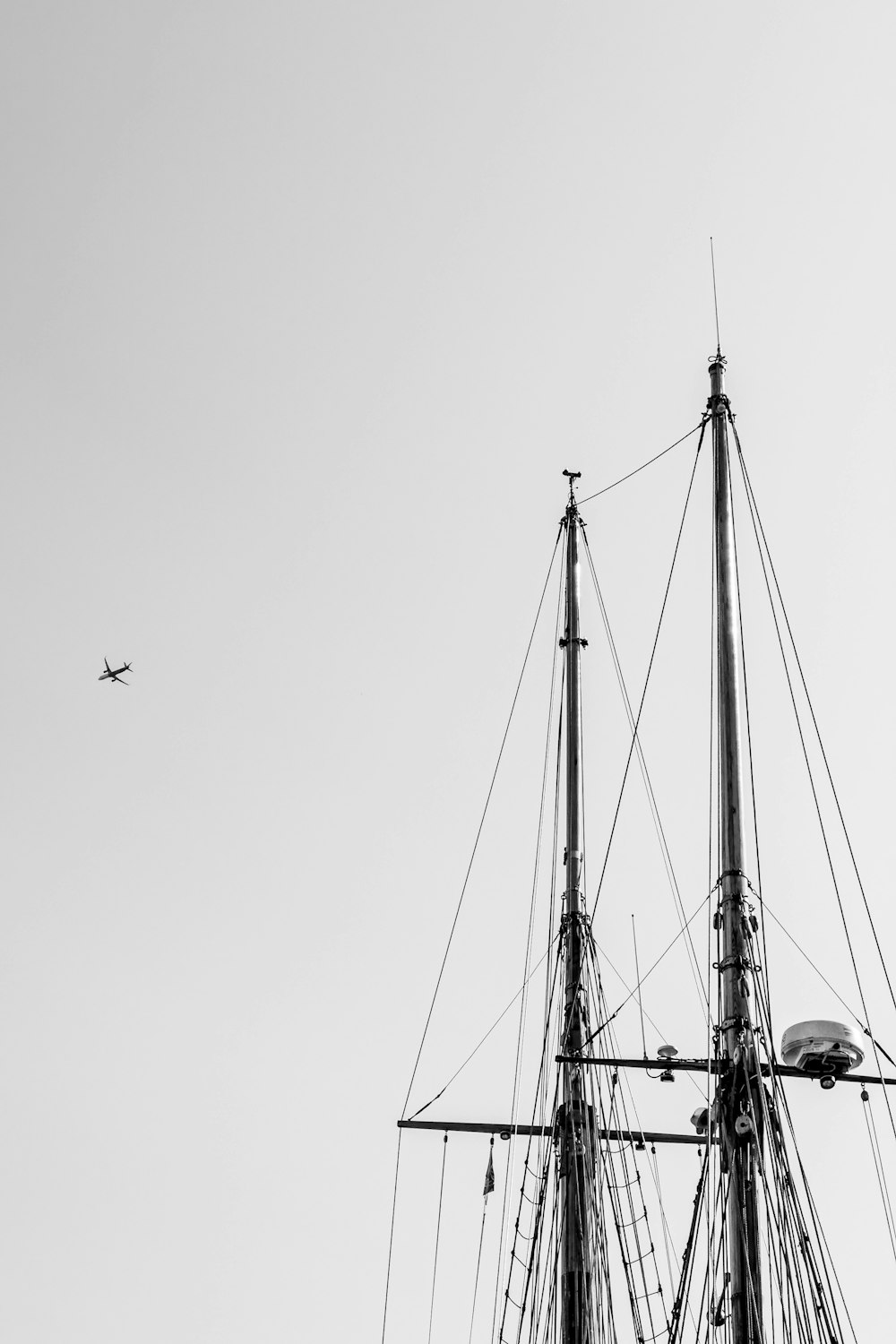 a plane flying over a ship in the sky