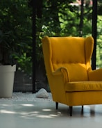 a yellow chair sitting on top of a white floor
