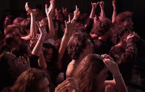 Guests raising their hands and enjoying the music in an intimate party setting