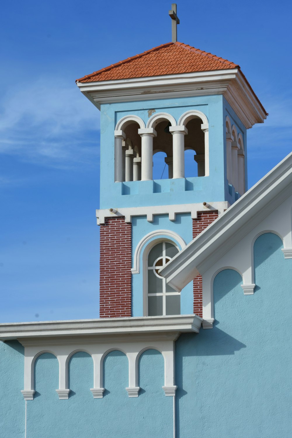 a blue building with a cross on top of it