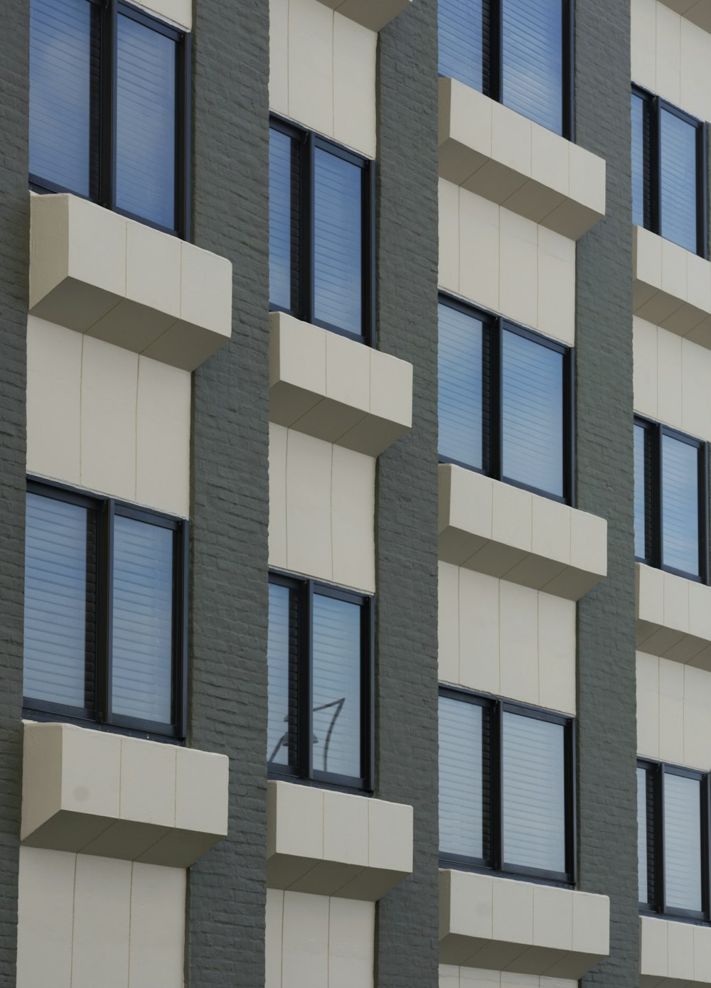 a tall building with many windows next to a clock