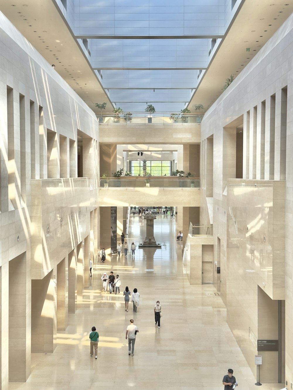 a group of people walking through a large building