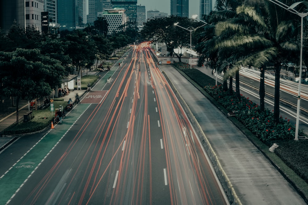 a city street filled with lots of traffic next to tall buildings