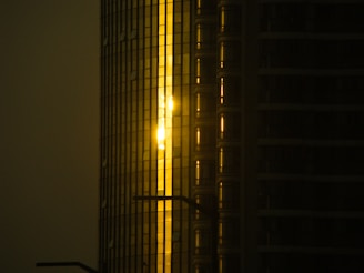 Sunset view of a luxury Miami high-rise with golden light reflecting off the glass.