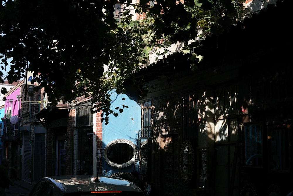 a car parked on the side of a road next to a building