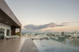 A sleek infinity edge pool overlooking a Perth skyline at sunset.