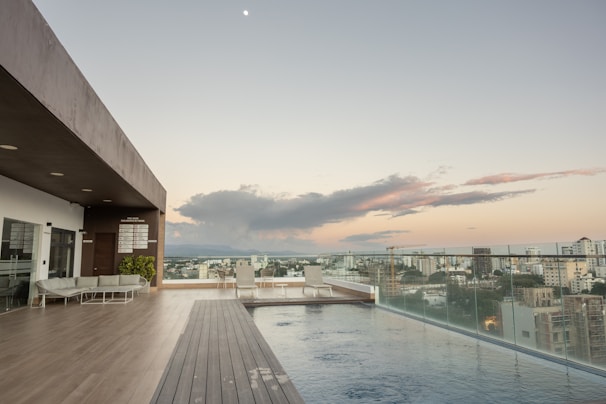 Rooftop infinity pool overlooking a stunning city skyline at sunset