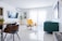 A beautifully renovated living room showcasing modern design with large windows and bright colors.