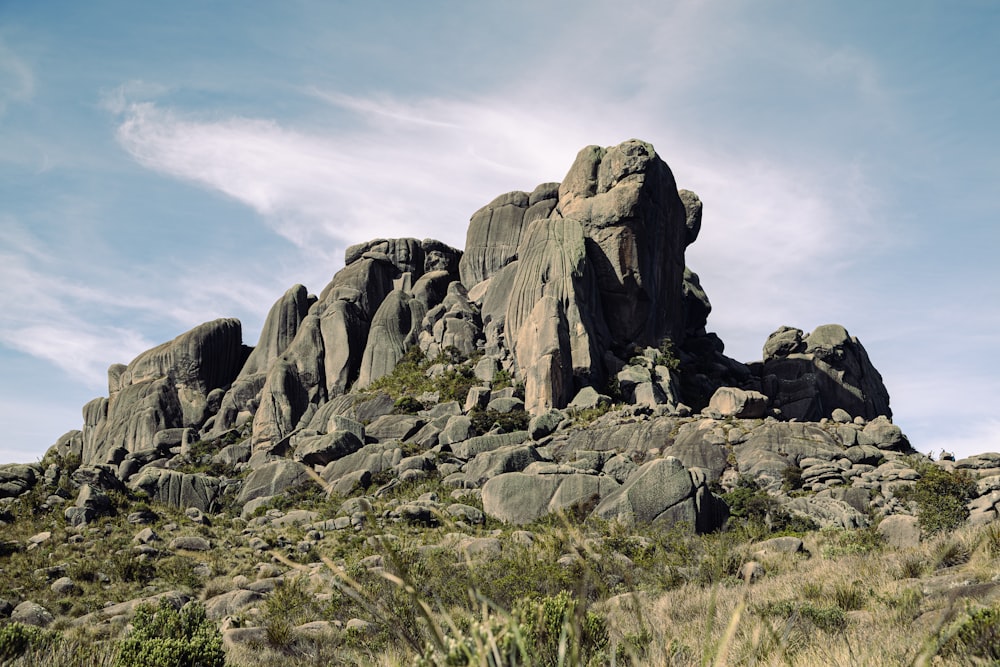 a large rock formation in the middle of a field
