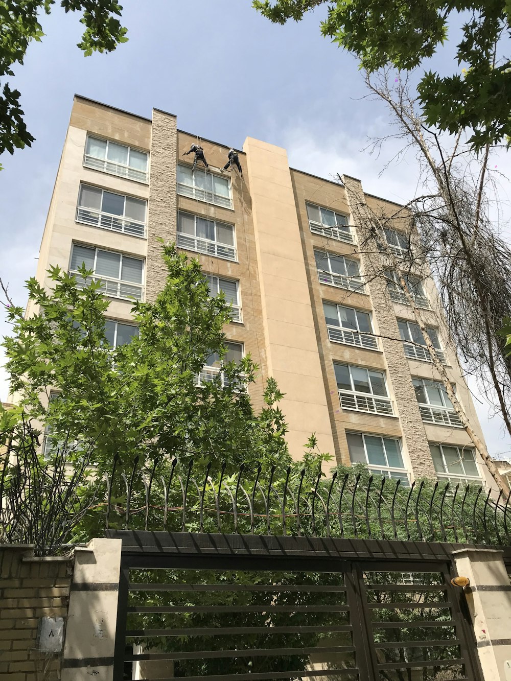 a tall building with many windows and a gate