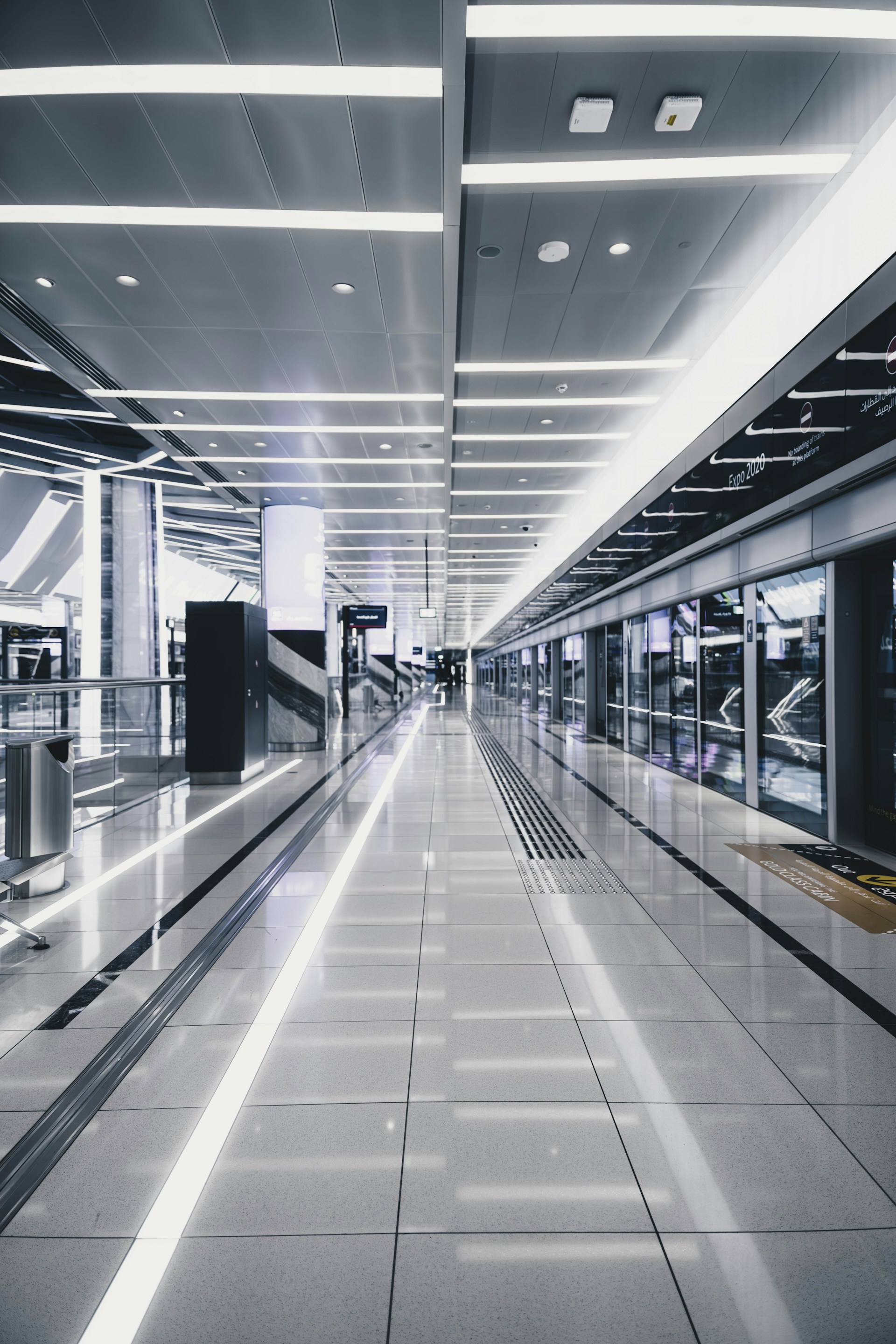 a long empty walkway in an airport terminal