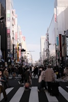 A lively cartoon scene of a bustling city street with colorful characters crossing.