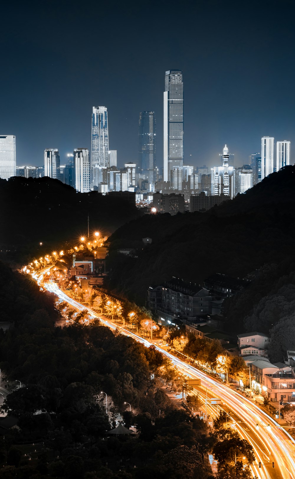 a view of a city at night from a hill