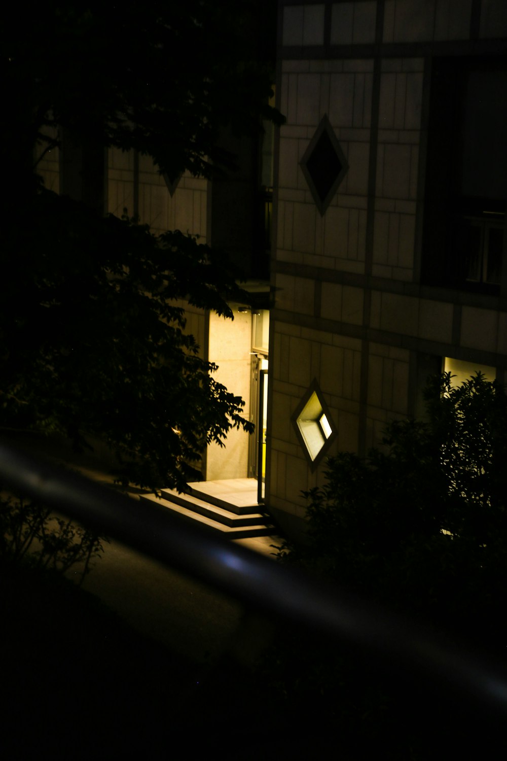 a building at night with a lit up door