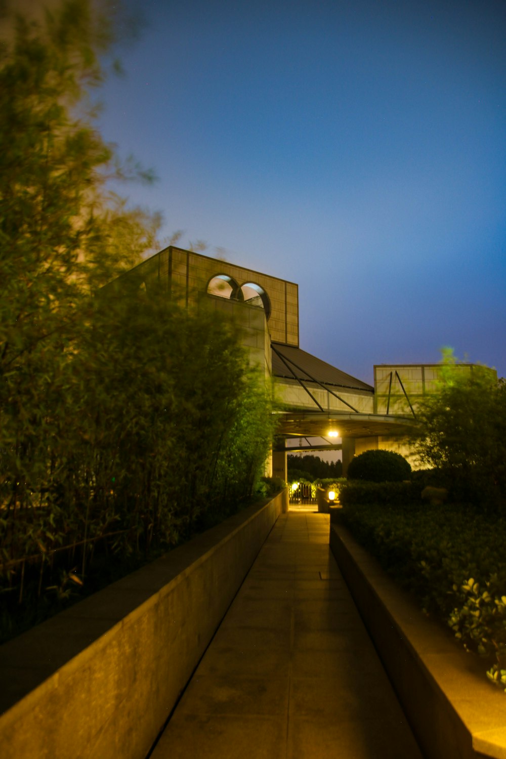 a long walkway with a building in the background