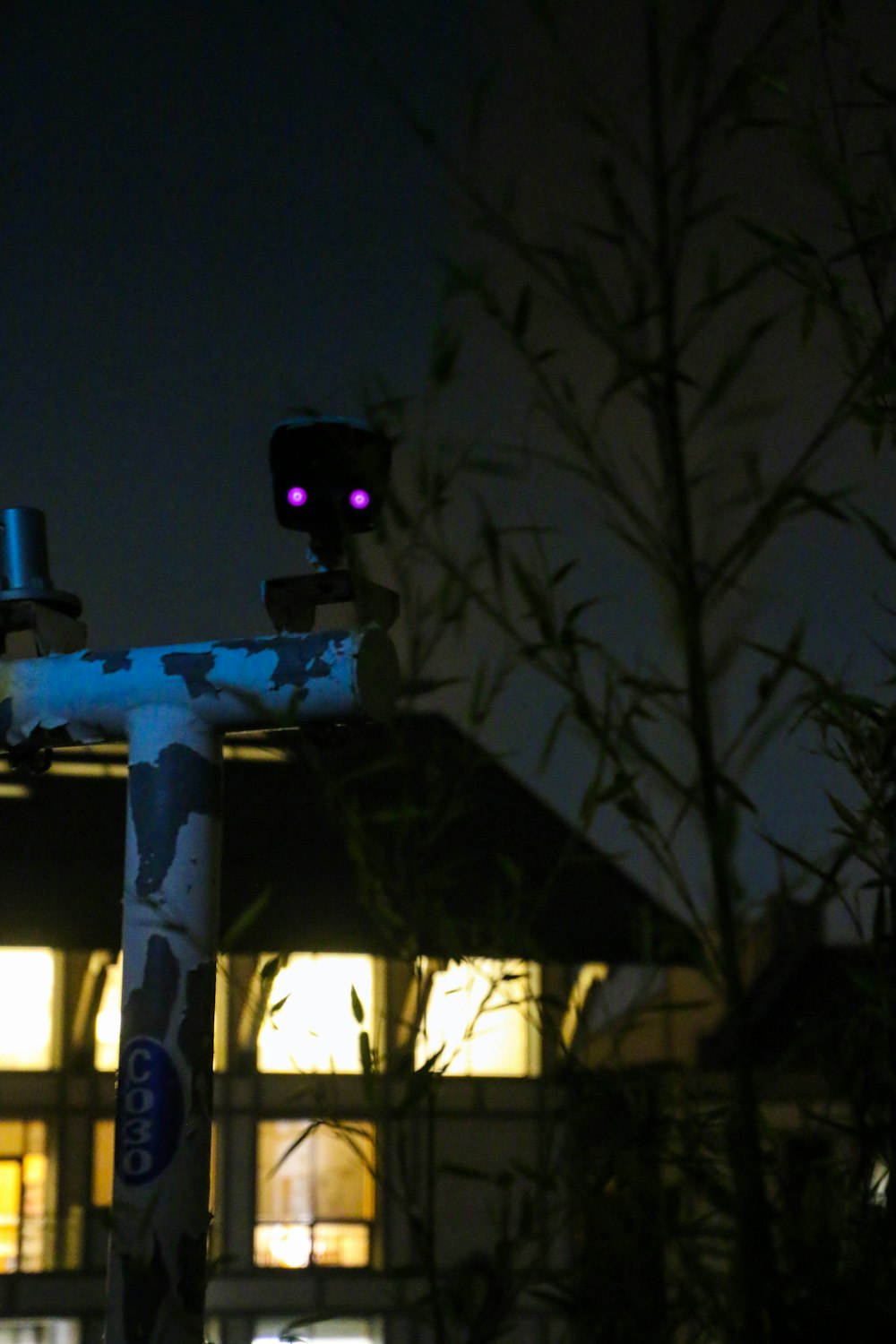 a street light with a building in the background