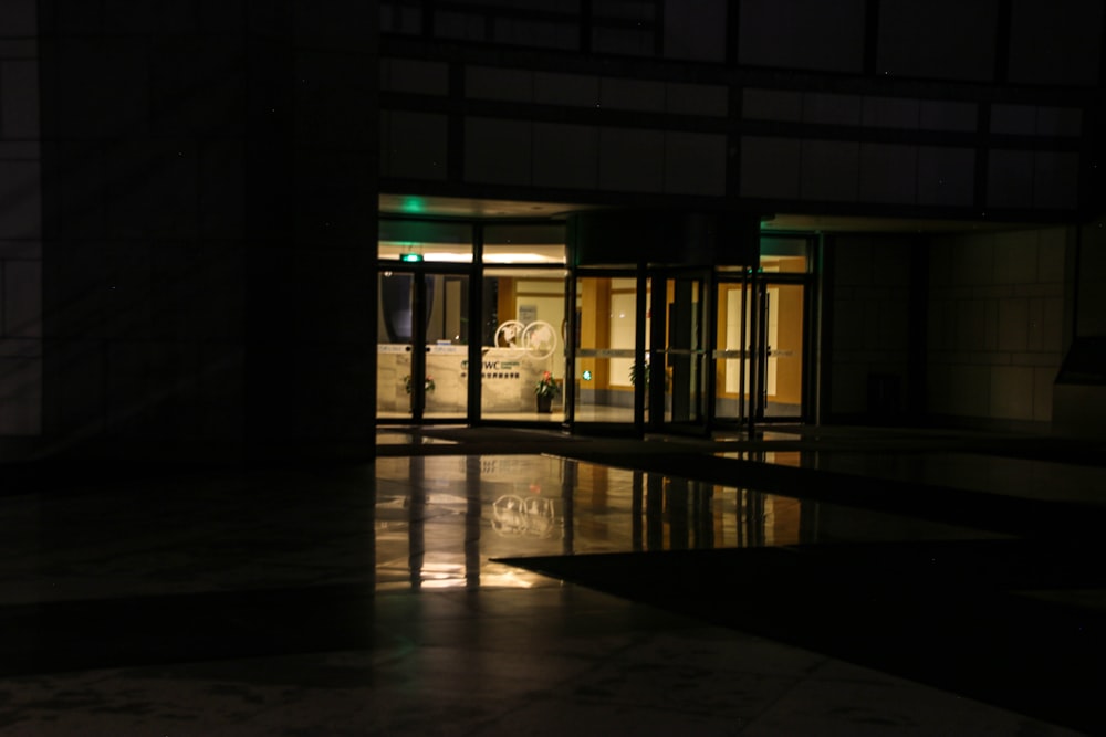 a dark room with a reflection of a car in the floor