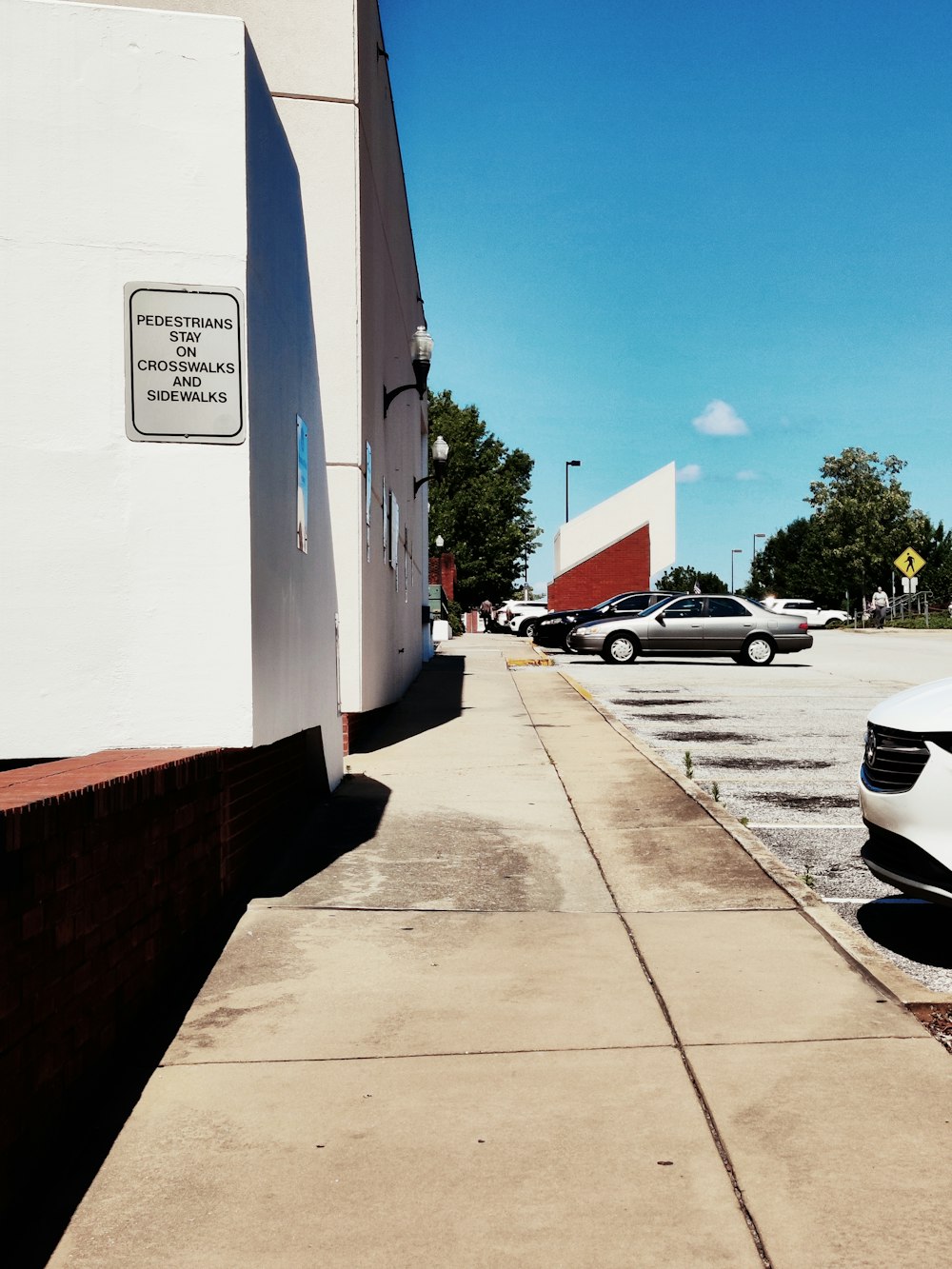 several cars parked in a parking lot next to a building