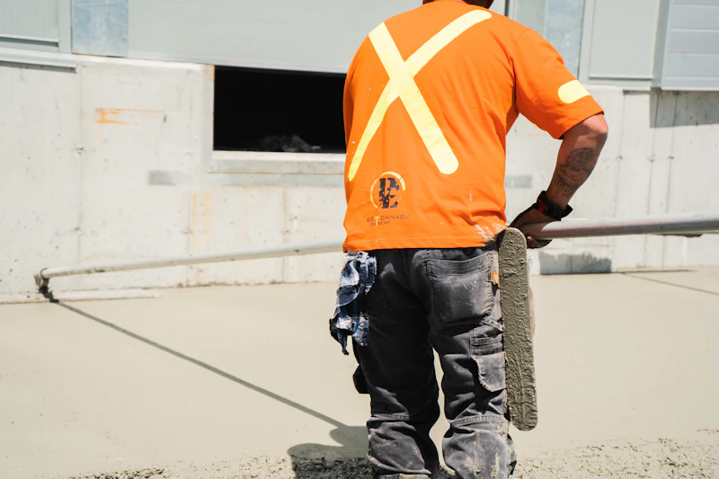A Bedrock Concrete tradesperson in hi-vis, mid-pour on site.