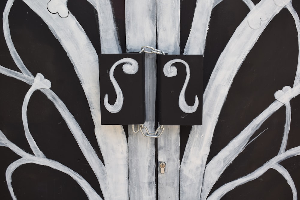 a white and black door with a metal handle
