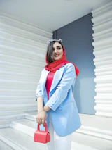 A smiling female engineer wearing a hijab at a construction site, symbolizing diversity and expertise.