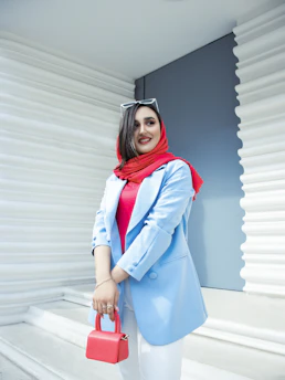 A smiling female engineer wearing a hijab at a construction site, symbolizing diversity and expertise.
