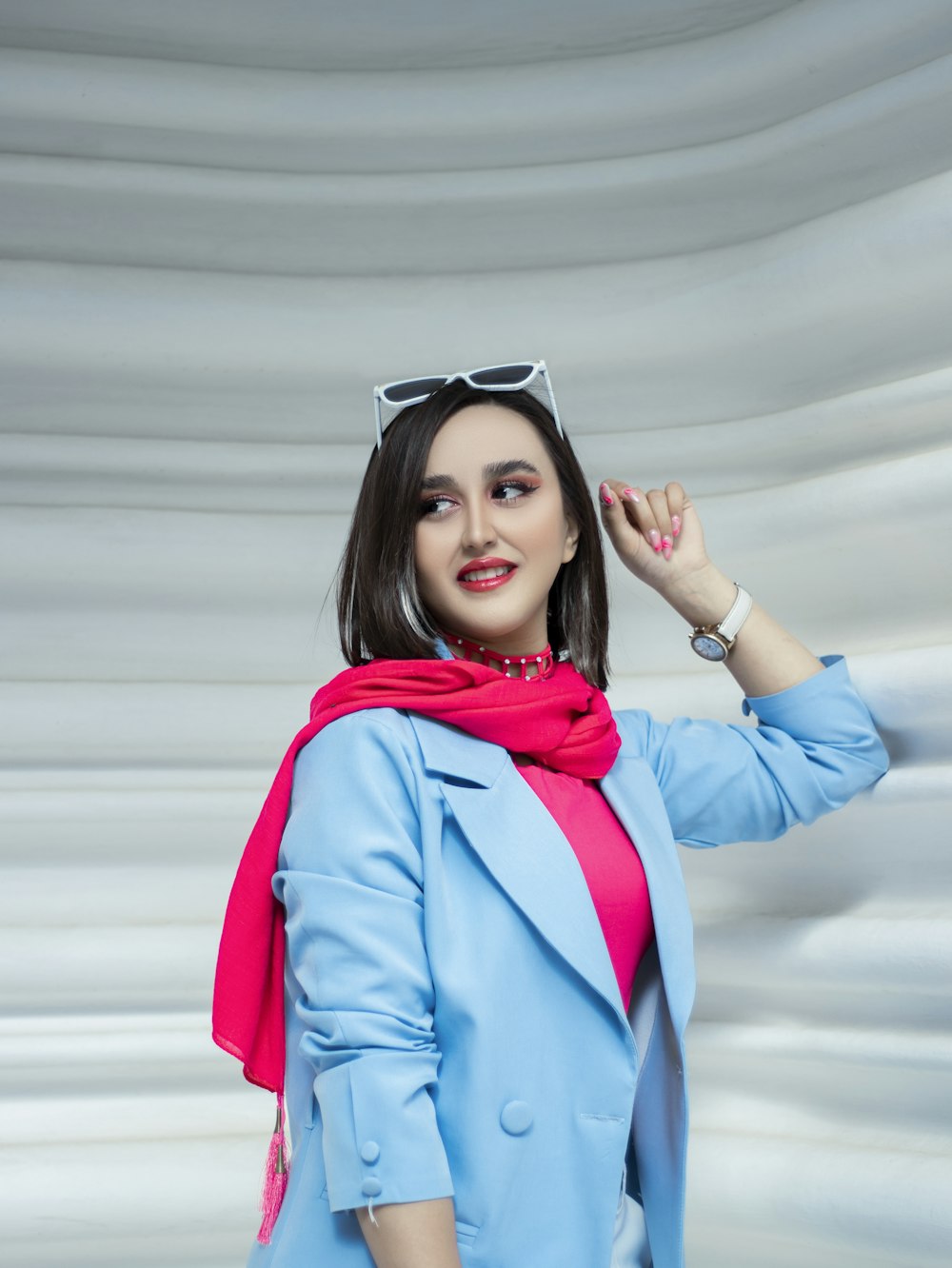 a woman in a blue coat and pink scarf