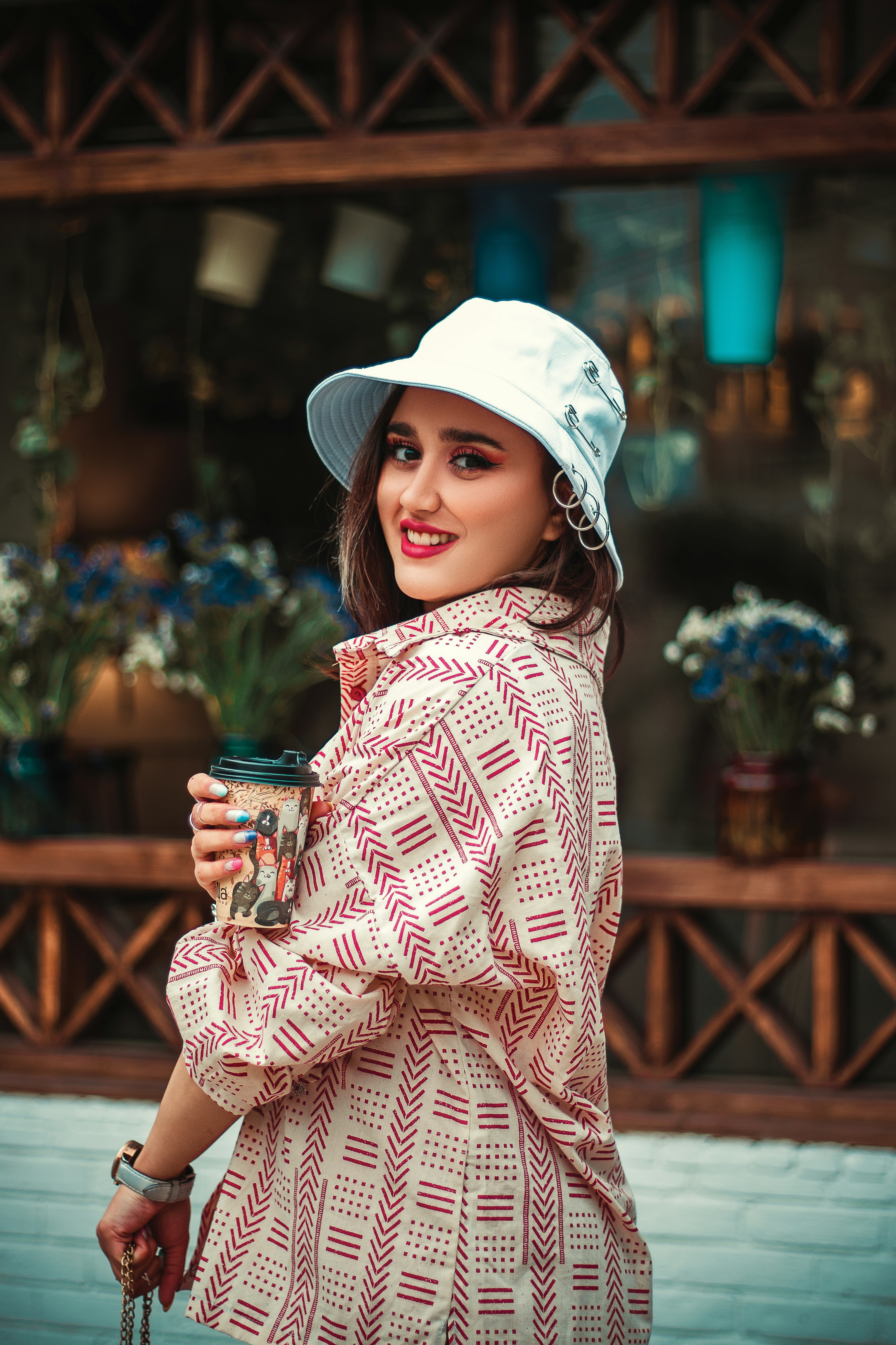 Una donna con un cappello bianco tiene in mano una tazza