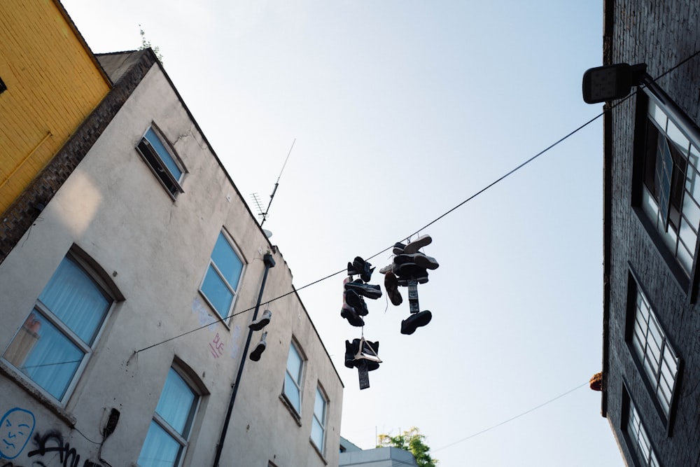 a pair of shoes hanging from a wire in front of a building