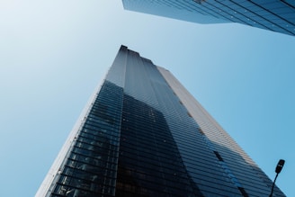 looking up at the top of a tall skyscraper