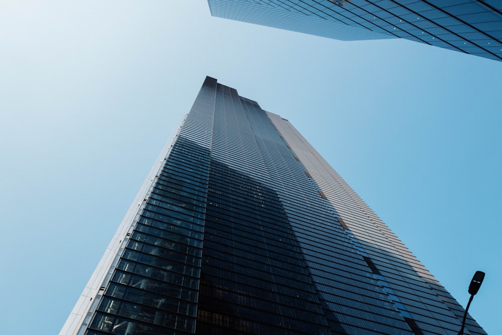 looking up at the top of a tall skyscraper