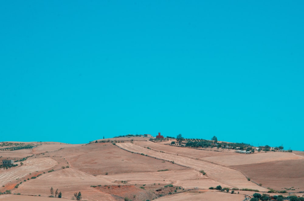 a view of a hill with a house on top of it