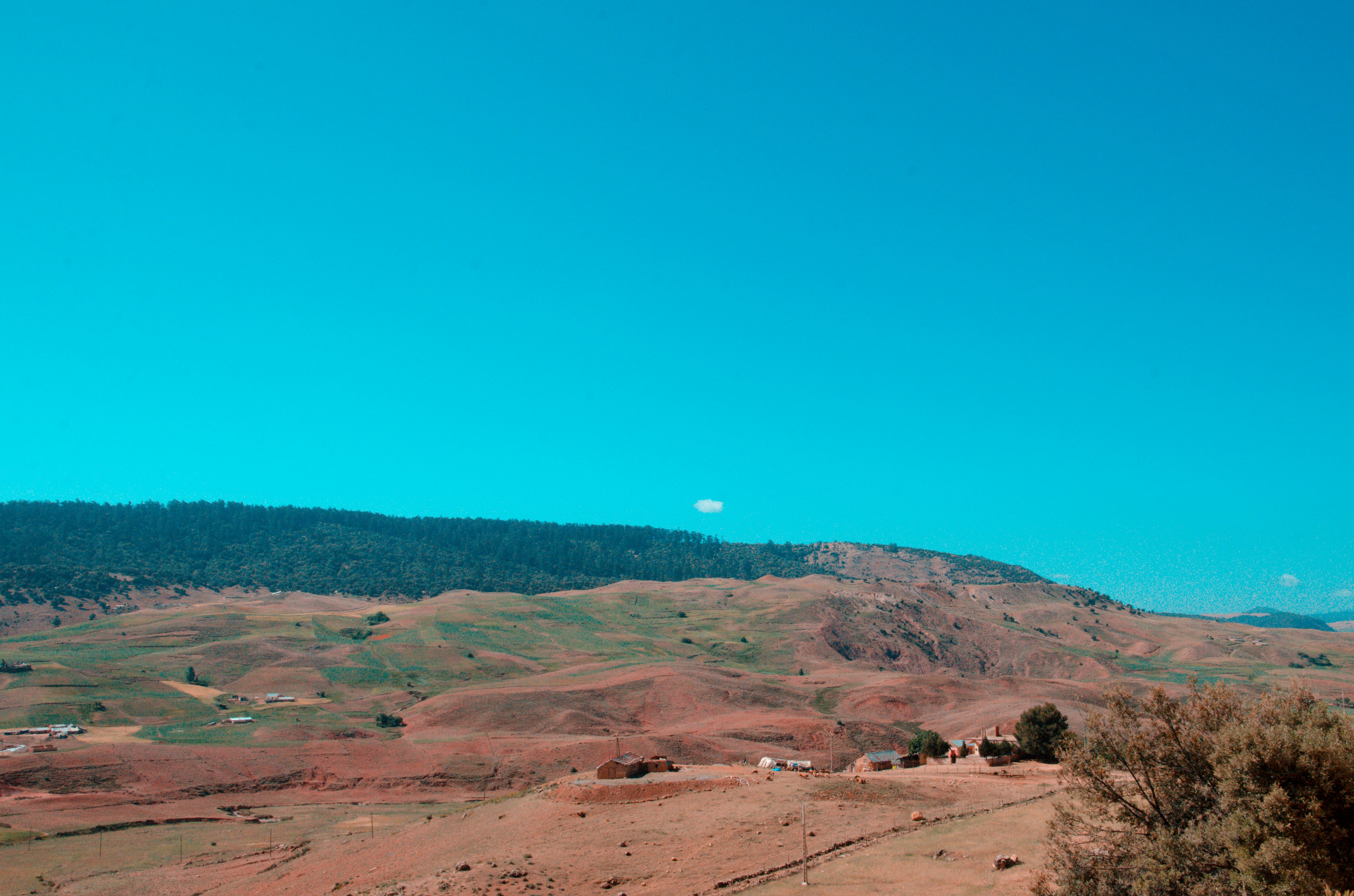 a view of a mountain range with a blue sky in the background