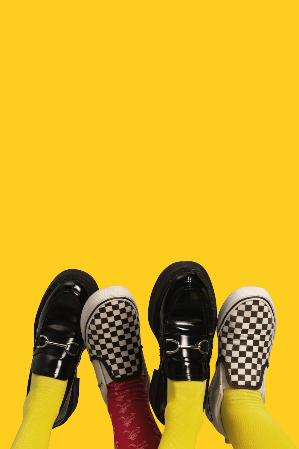 three pairs of black and white checkered shoes