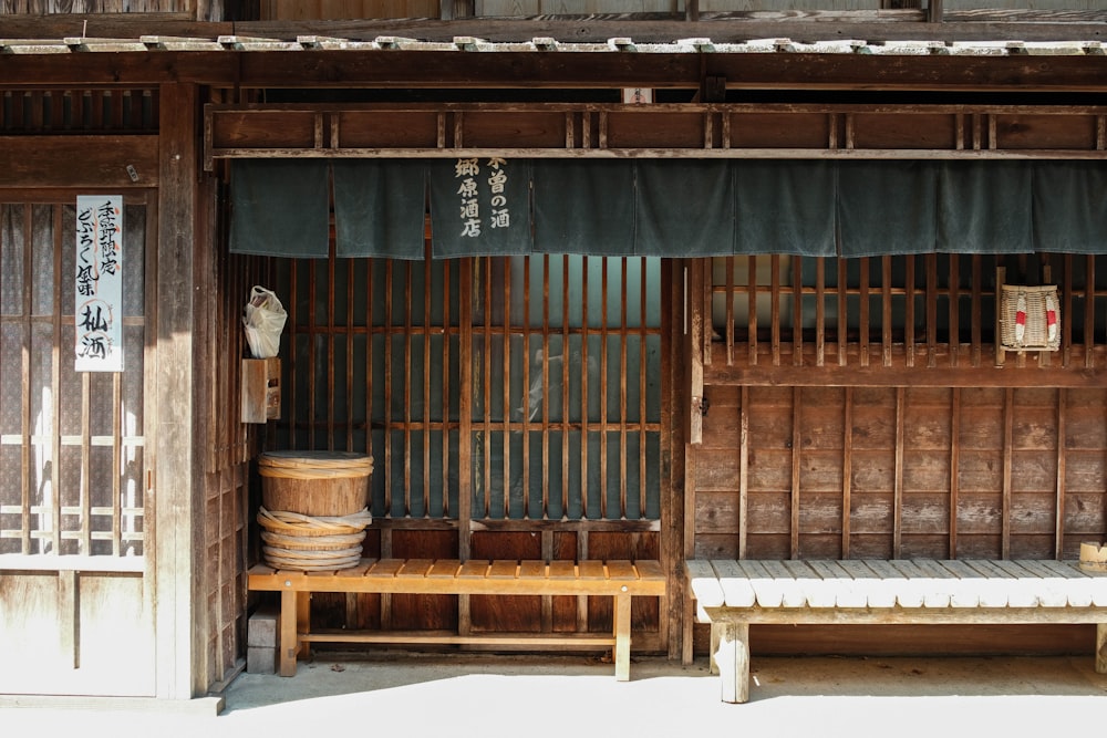 a wooden bench sitting in front of a building