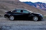 A sleek sedan parked in a scenic location.