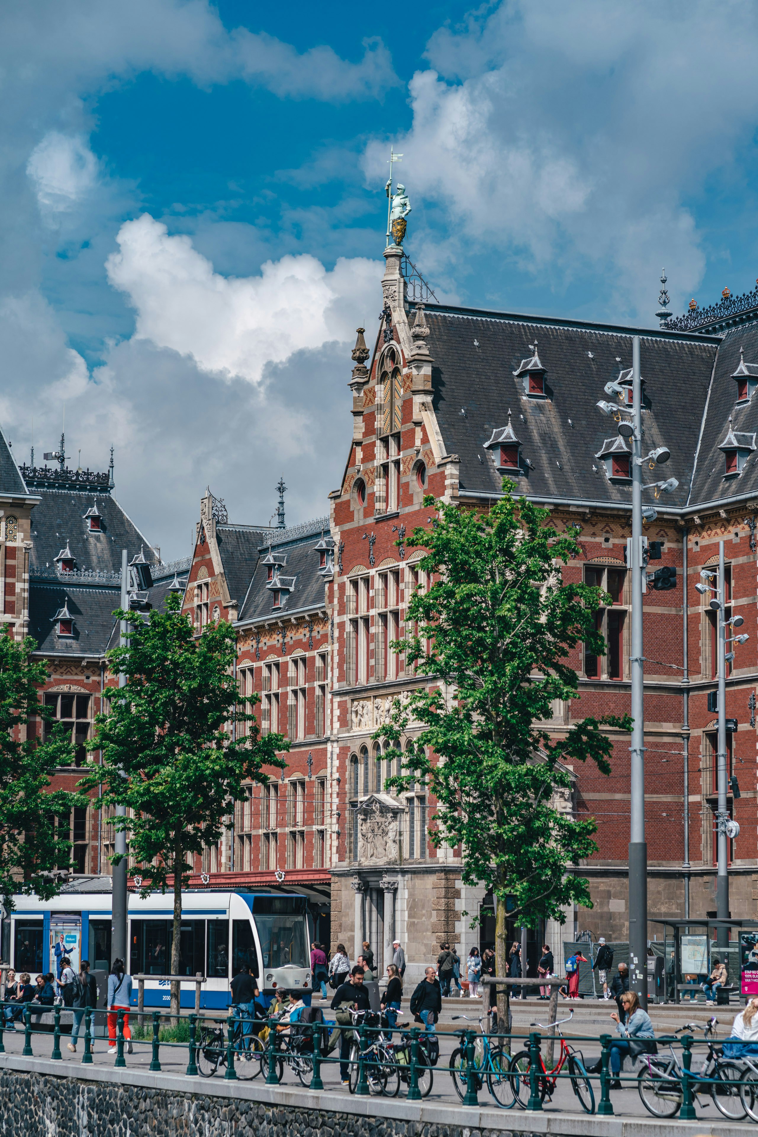 a group of people riding bikes next to a tall building