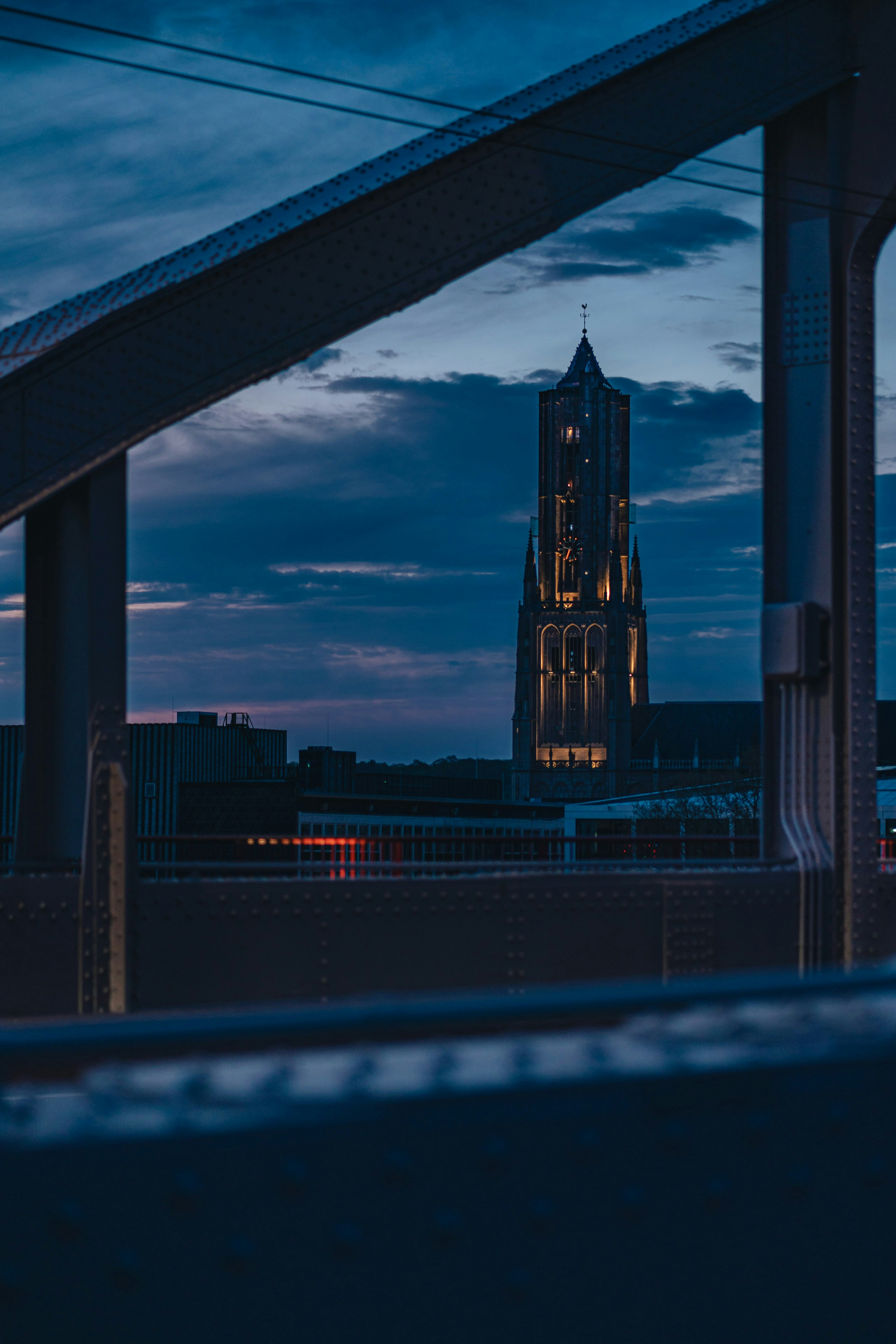 a view of a clock tower from a bridge